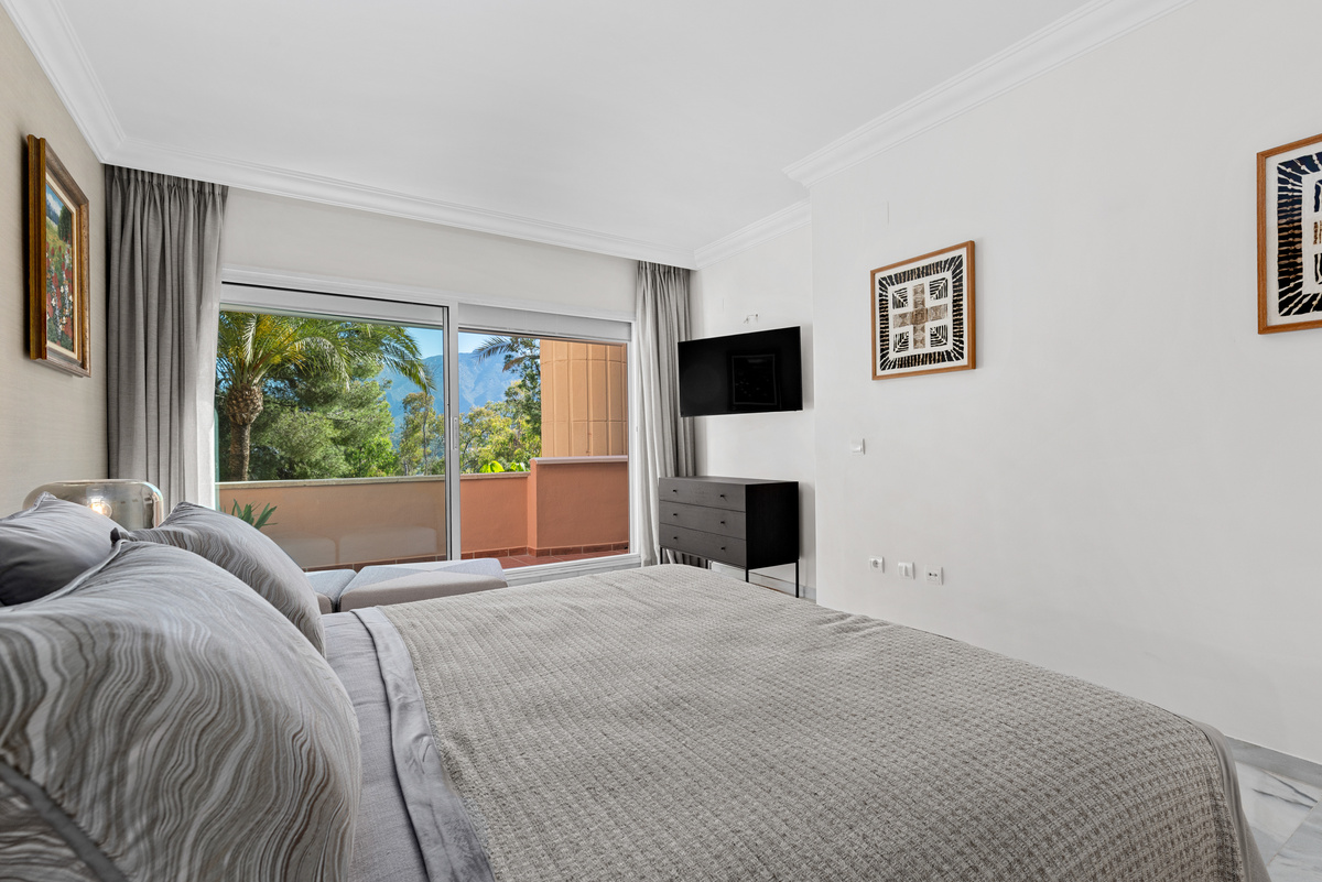 Bedroom with balcony and mountain views