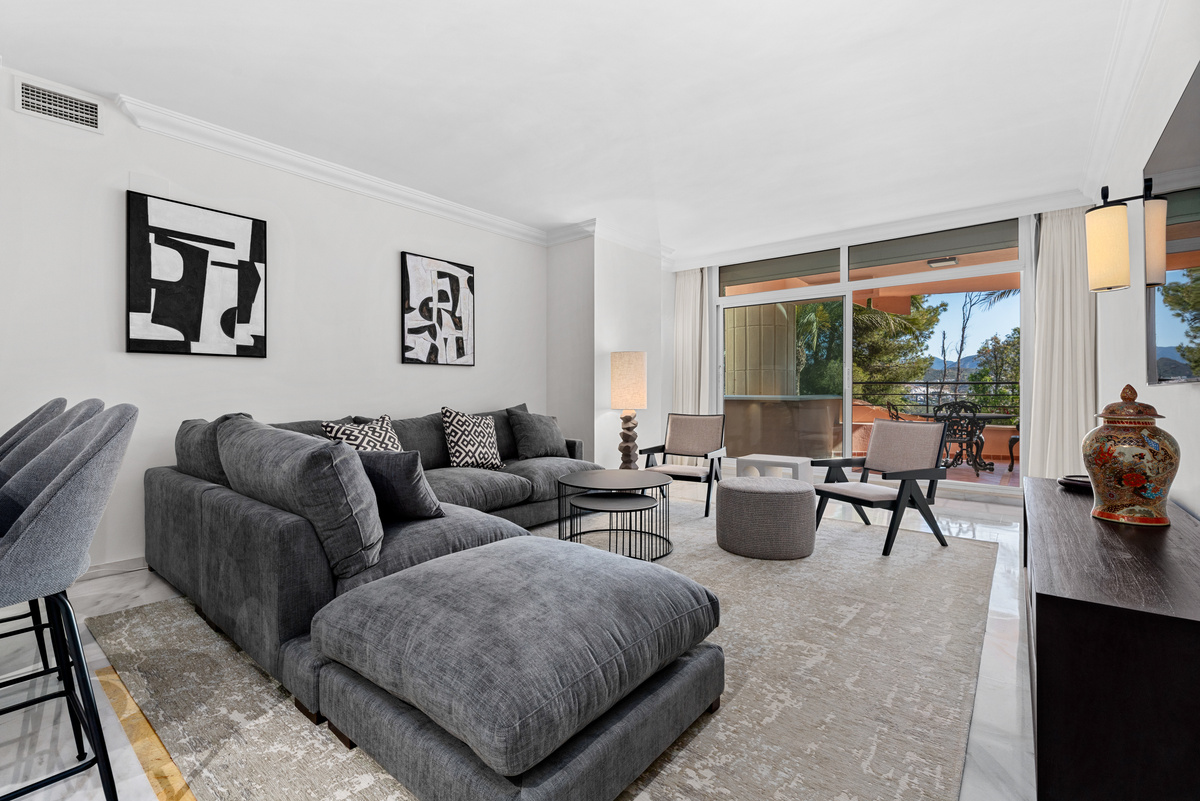 Living room with sectional sofa and balcony