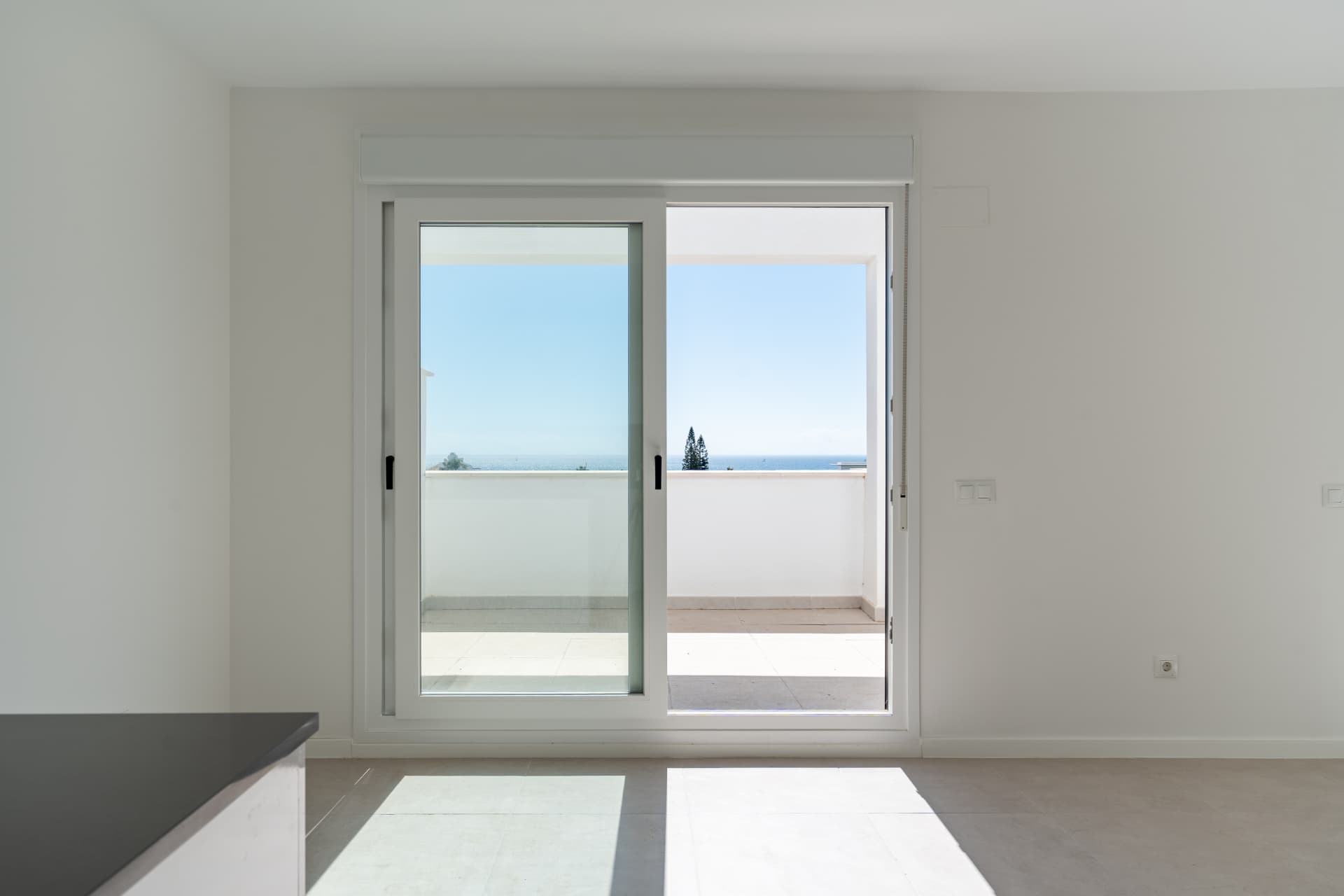 Sliding doors opening to the terrace with sea views