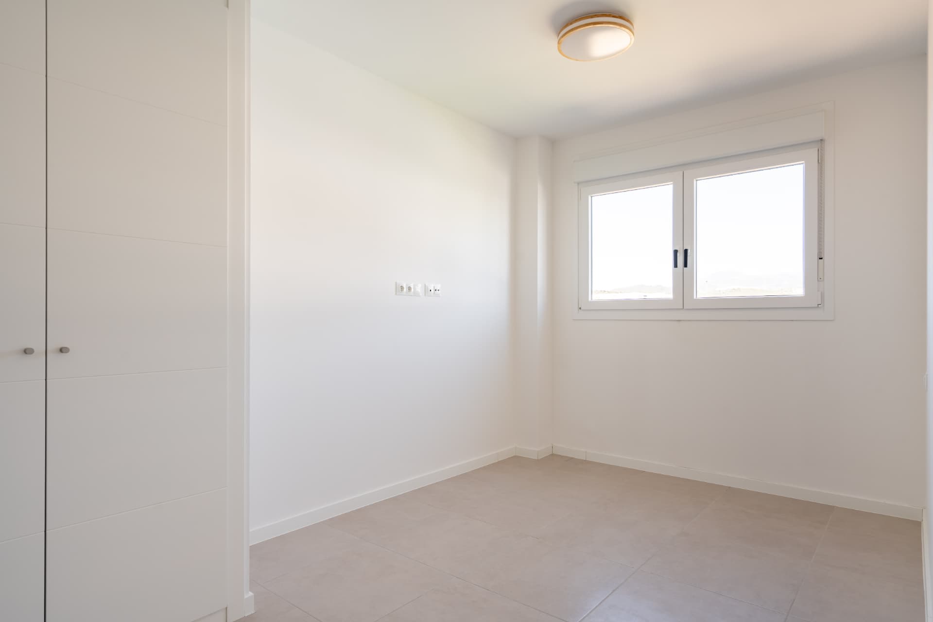 Third bedroom with fitted wardrobe and mountain view window